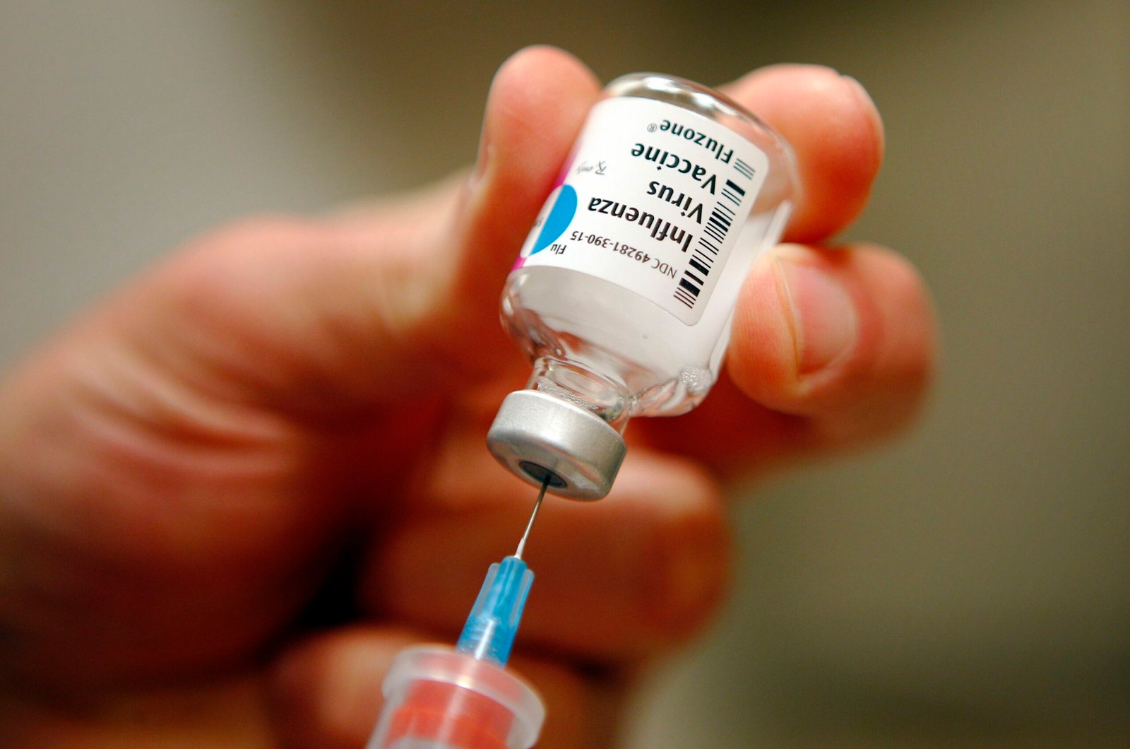 File photo of a nurse preparing an injection of the influenza vaccine at Massachusetts General Hospital in Boston