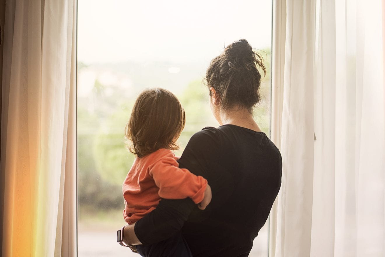 Mother-and-son-looking-out-of-window-1130186653_2123x1417-scaled-1